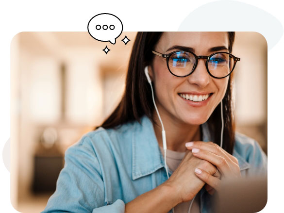 A woman wearing glasses and headphones while using her laptop.